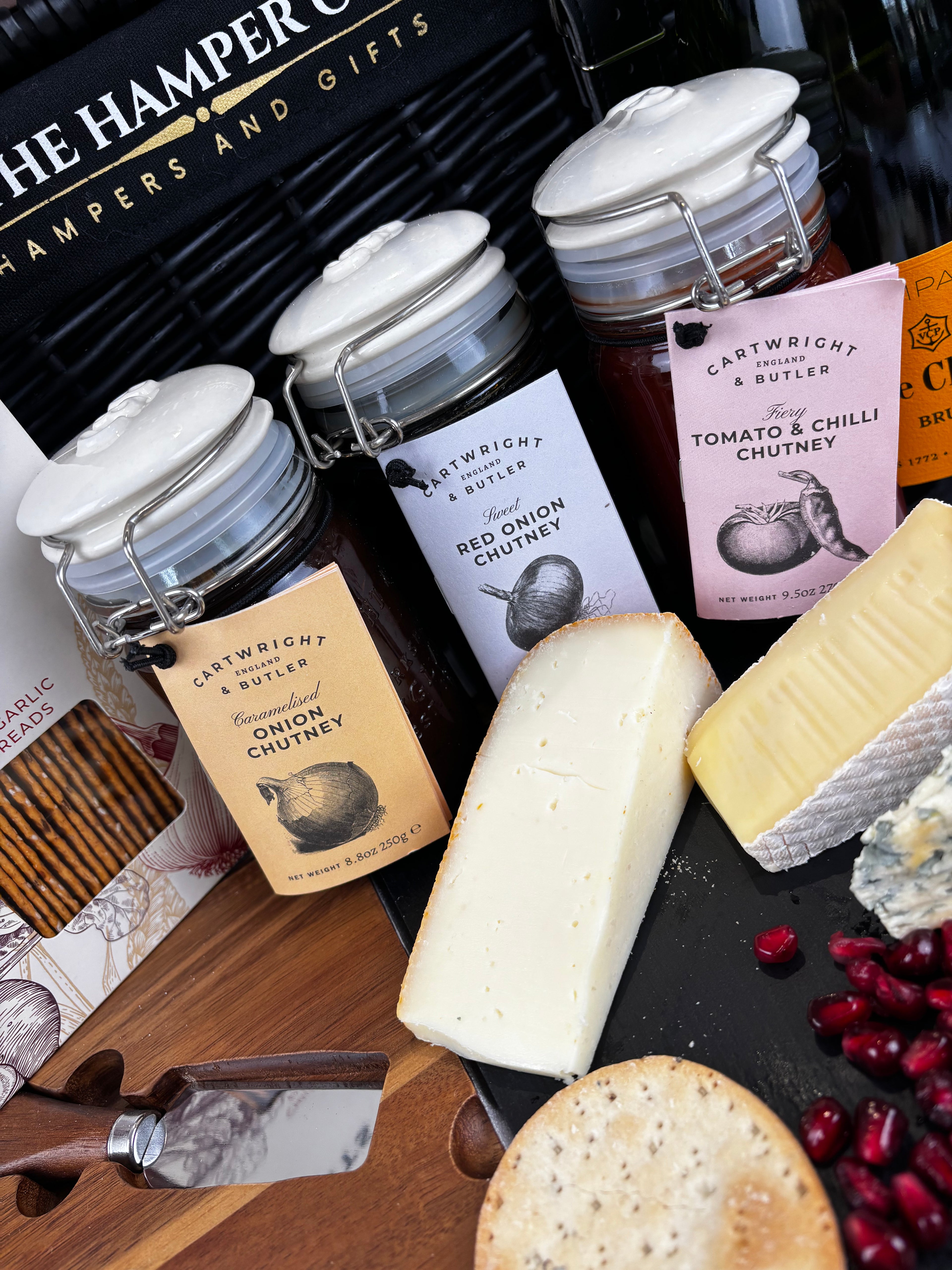 cartwright & butler chutneys, selection of cheese o a lytton house acacia wood cheese board, the hamper co hamper in the background