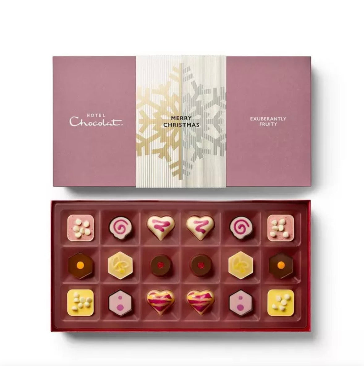 A boxed assortment of chocolates shown open below its matching lid. The packaging is dusty mauve with a central white panel featuring gold and silver snowflakes and the text 'Merry Christmas' and 'Hotel Chocolat.