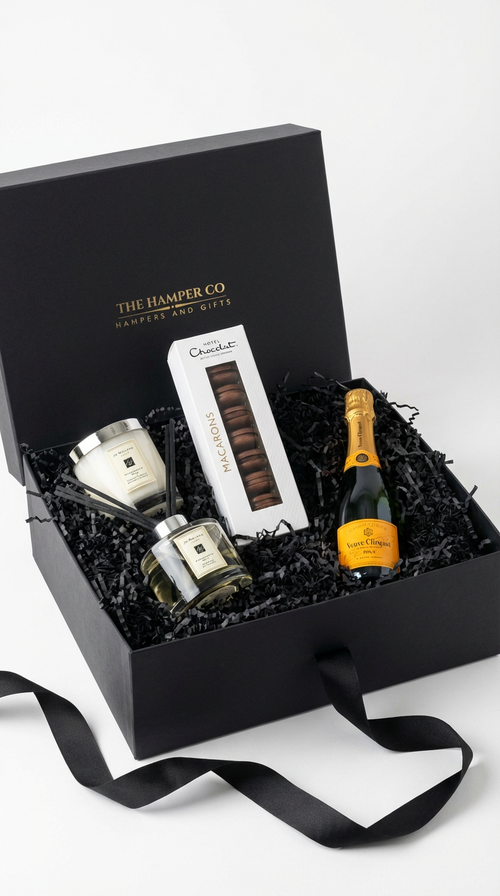 lucky gift box with verve clicquot champagne, hotel chocolat maarons, jo malone 200g candle and jo malone 165ml diffuser, set on a whte professional background.