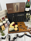 a luxury hamper with cartwright  & butler products, cheese board, moet & chardon champage, hotel chocolat 18 piece everything bo. luxury hampers