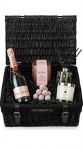 luxury hamper gift basket with jo malone candle and jo malone reed diffuser with rose moet & chardon champagne and hotel chocolat pink champagne truffles set on a white background