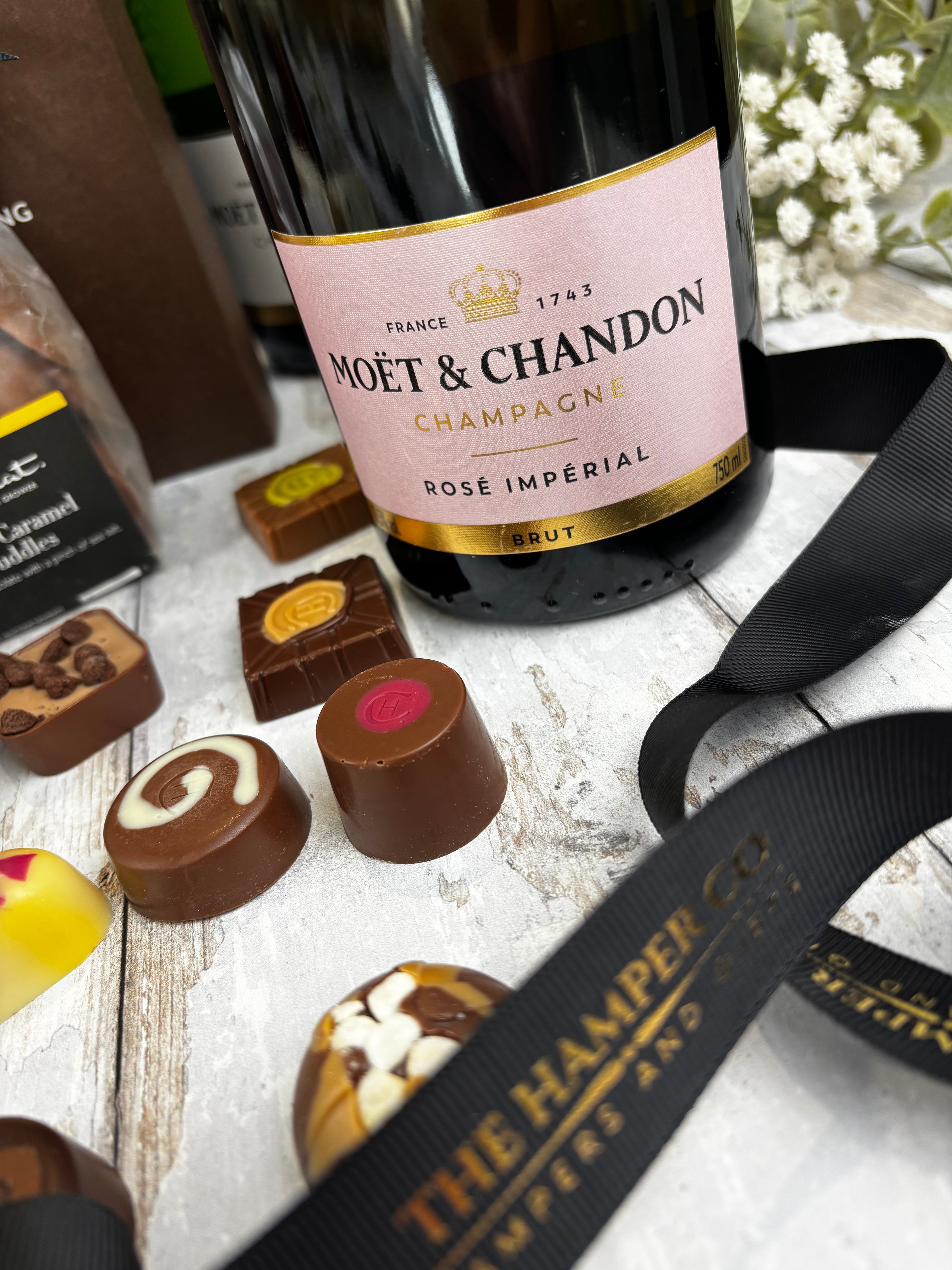rose imperial moet & chardon close up with ribbon and hotel chocolat selection